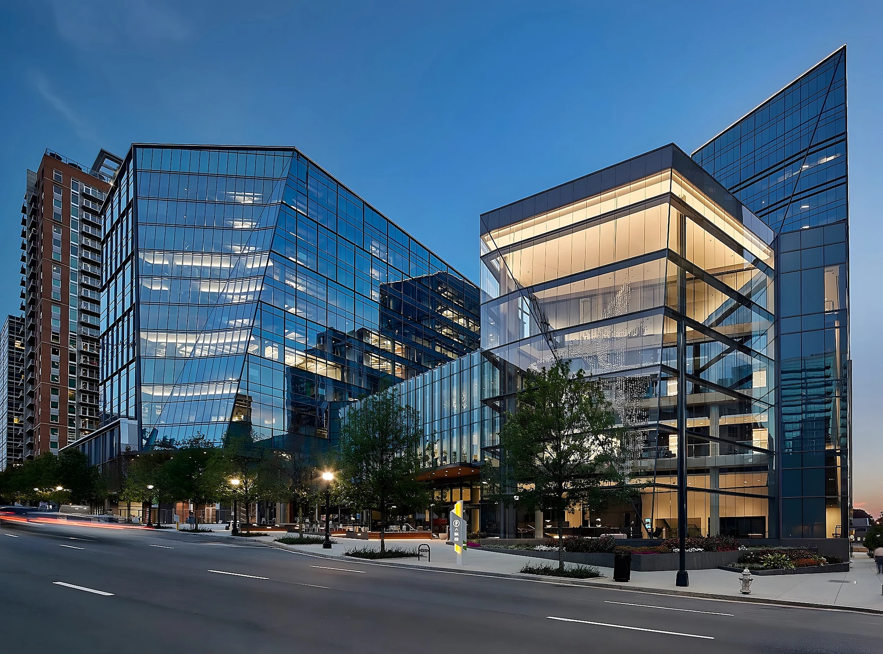 Commercial construction glass-fronted office building at dusk