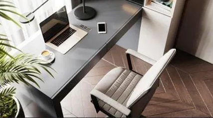 Study area with an upholstered desk chair and natural light